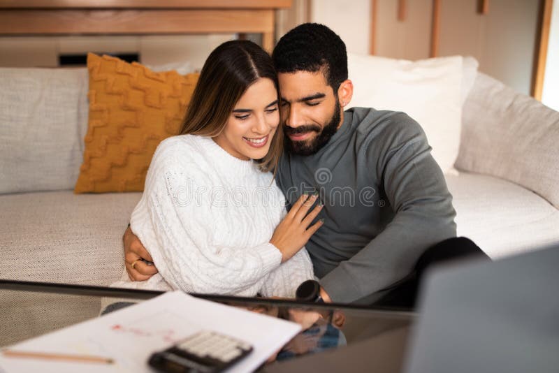 Glad Millennial Arab Husband Hugging Caucasian Wife Have Video Call Enjoy Free Time With 