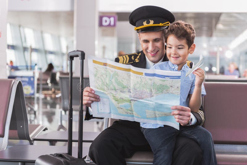 Glad smiling pilot spending time with child royalty free stock photography