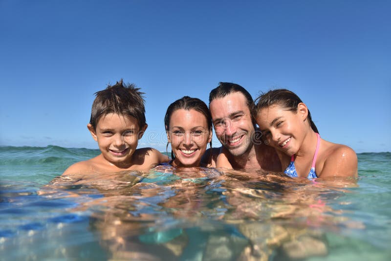 Glad ung familjsimning i havet arkivbilder Glad ung familjsimning i havet arkivbilder