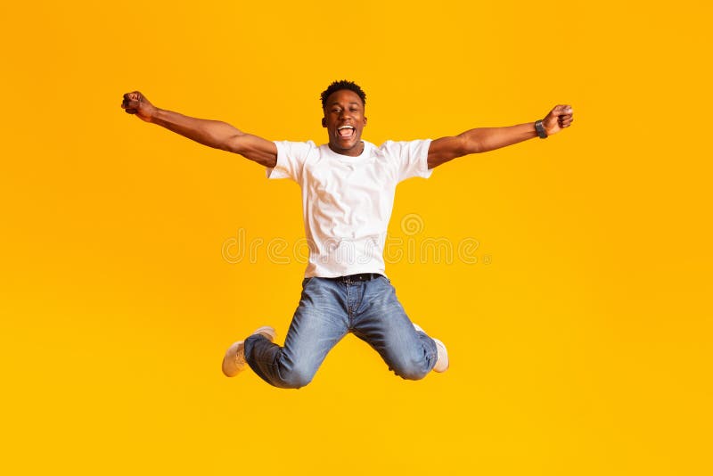 Glad upphetsad afrikansk man som hoppar i flygdans arkivbilder