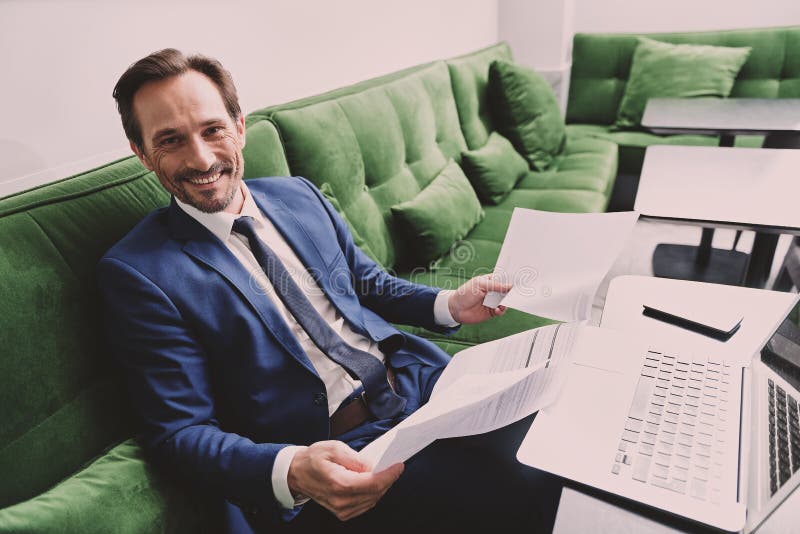 Glade affärsmanläsningdokument med tillfredsställelse royaltyfria bilder Glade affärsmanläsningdokument med tillfredsställelse royaltyfria bilder