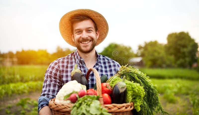 Cheerful farmer with organic vegetables in garden. Cheerful farmer with organic vegetables in garden