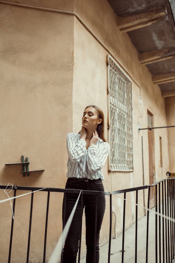 Glamorous Brunette Woman in Shirt Posing in the Passage Stock Photo ...