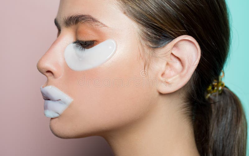 Glamorous healthy model with beautiful face using patches for eyes and lip. Spa skin procedure for health and beauty royalty free stock image Glamorous healthy model with beautiful face using patches for eyes and lip. Spa skin procedure for health and beauty royalty free stock image