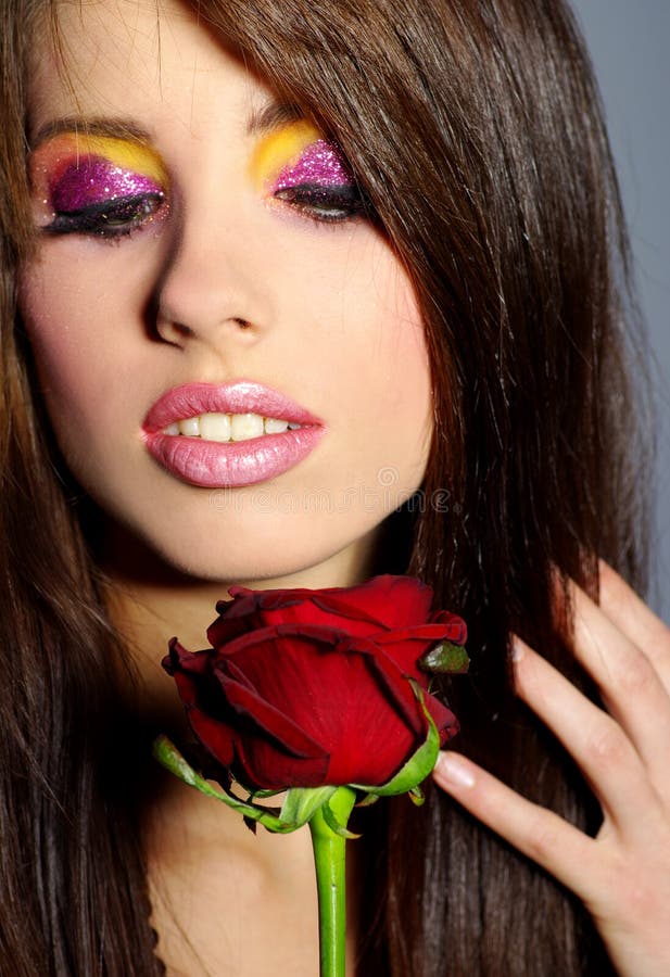 Glamorous woman with red rose