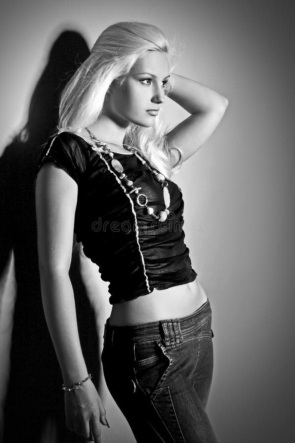 Home portrait of a beautiful young blonde woman in a white shirt and red bra.  Grain effect. Stock Photo