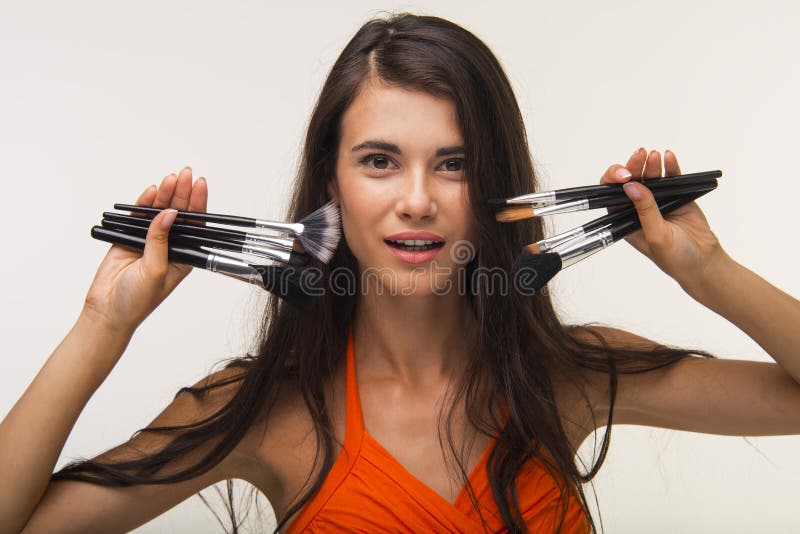 Glamour lady is showing cosmetic brushes. royalty free stock photo Glamour lady is showing cosmetic brushes. royalty free stock photo