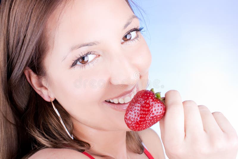 Glamour woman eating fresh strawberry