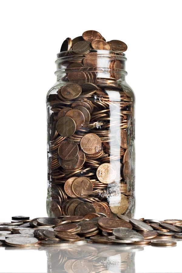 Jar of pennies on a reflective tabletop. Jar of pennies on a reflective tabletop