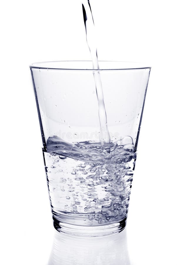 Water being poured into a glass. Isolated against a white background. Water being poured into a glass. Isolated against a white background.