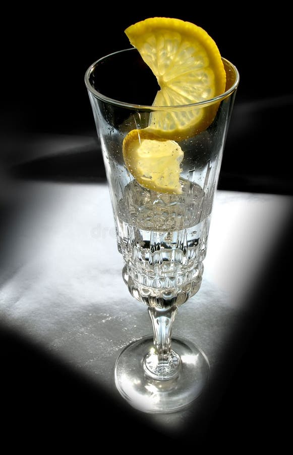 Glass of alcohol drink with lemon