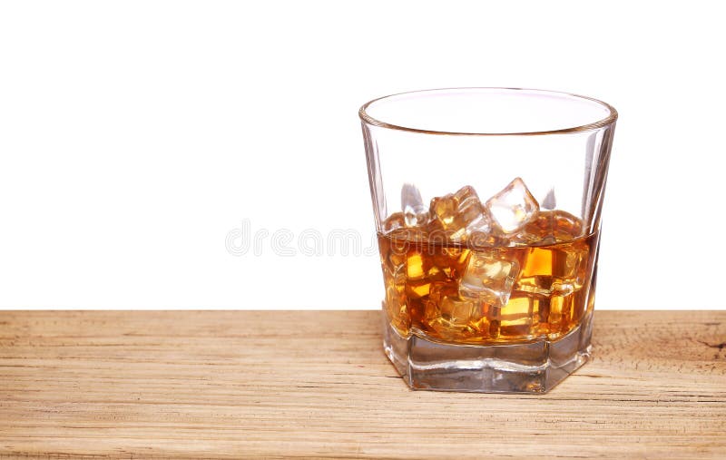 Glass Of Alcohol Scotch Whiskey With Ice Cube On Wooden Table Stock