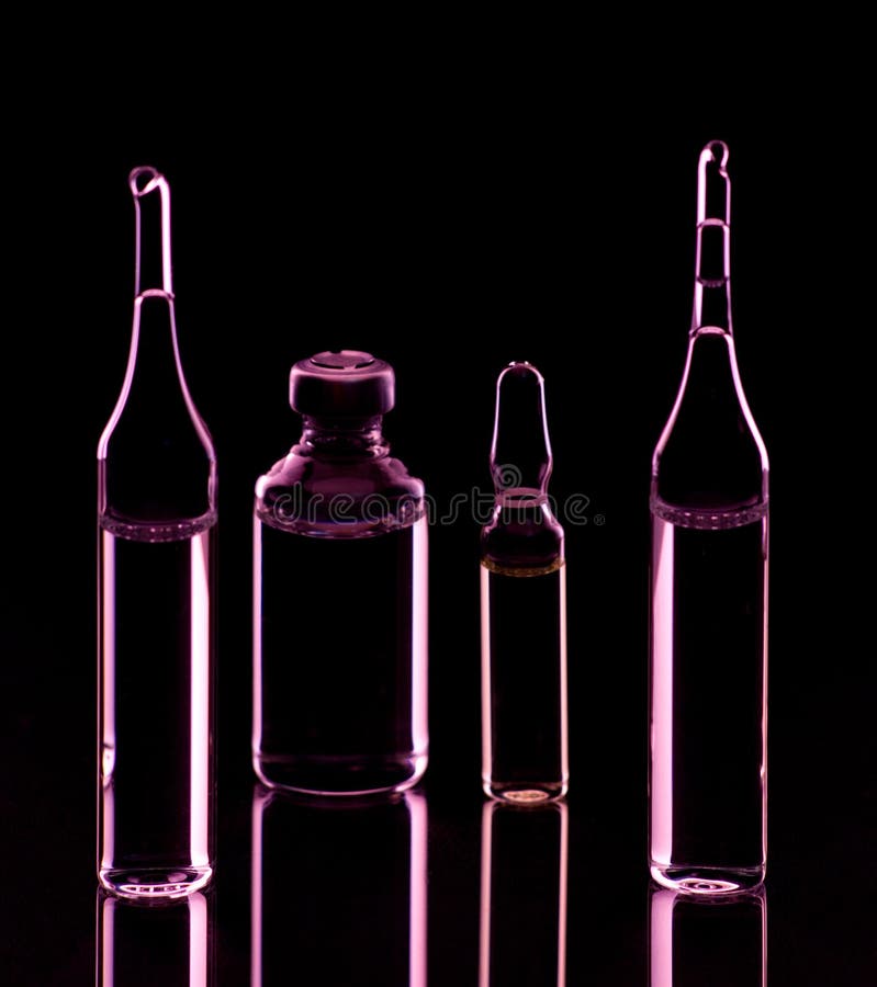 Glass Ampoules with Liquid on a Neon Background and on a Mirror Surface. Medical Equipment