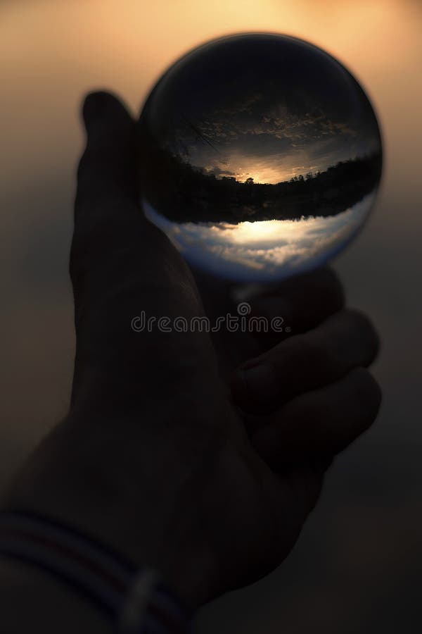 Glass Ball in Hand with Sunset Reflection Stock Photo Image of