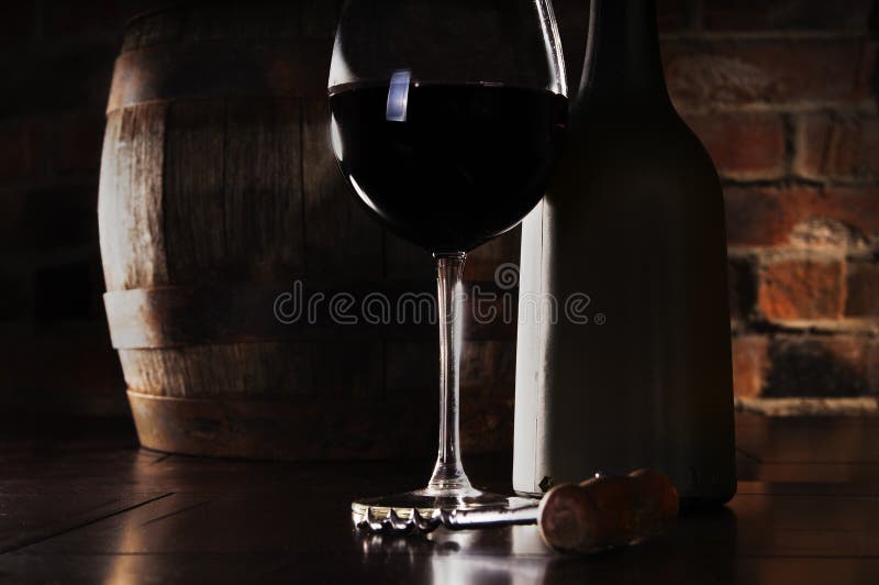 Glass, barrel and a bottle of red wine