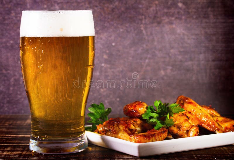 Glass of Beer and Buffalo Chicken Wings. Beer Bites. Stock Image