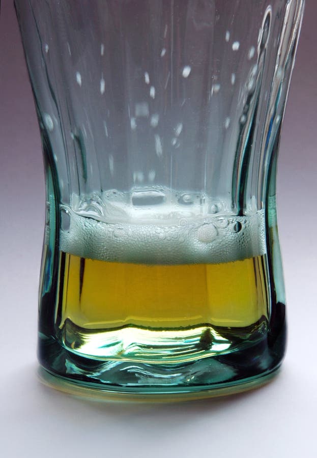 Glass of beer - almost empty stock images Glass of beer - almost empty stock images
