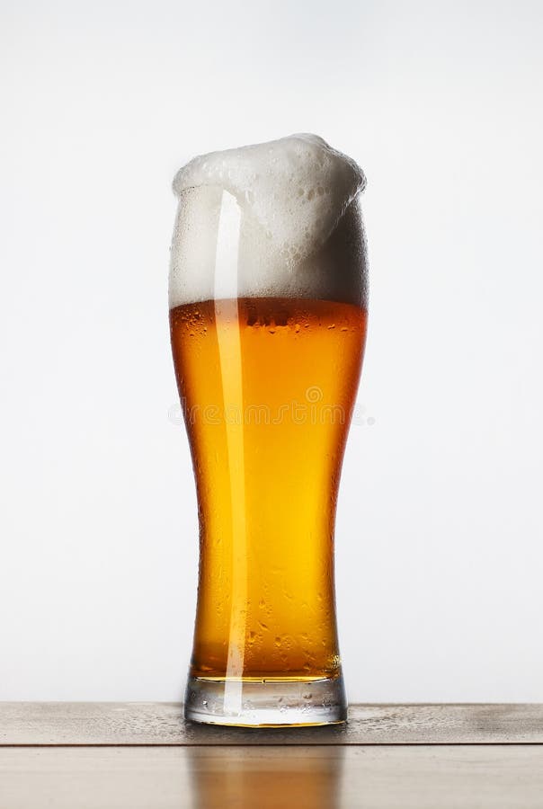 A glass of beer with foam. stock photo. Image of glass 128212988