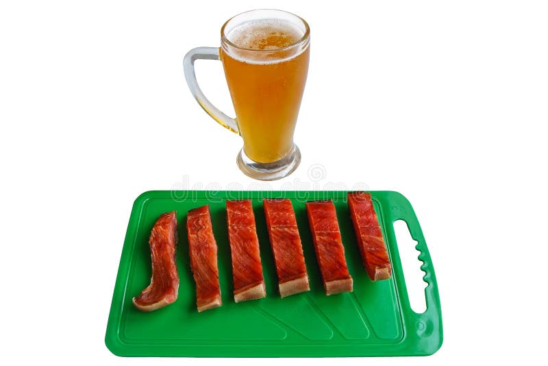 Glass of beer and pieces of red salmon fish on a green chopping board royalty free stock photography Glass of beer and pieces of red salmon fish on a green chopping board royalty free stock photography