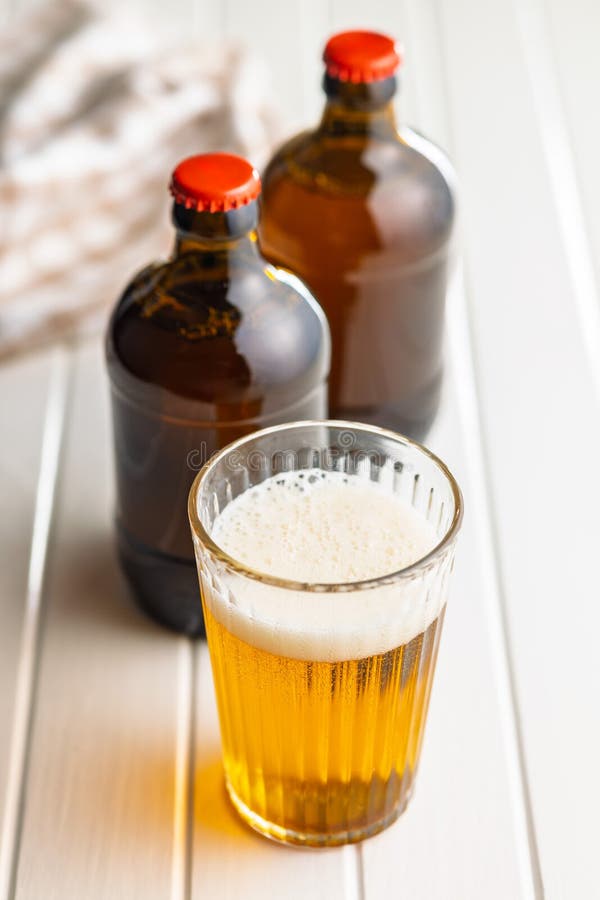 Glass of beer on white table royalty free stock photo