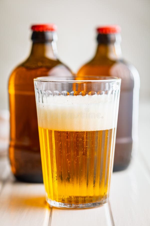 Glass of beer on white table royalty free stock photos