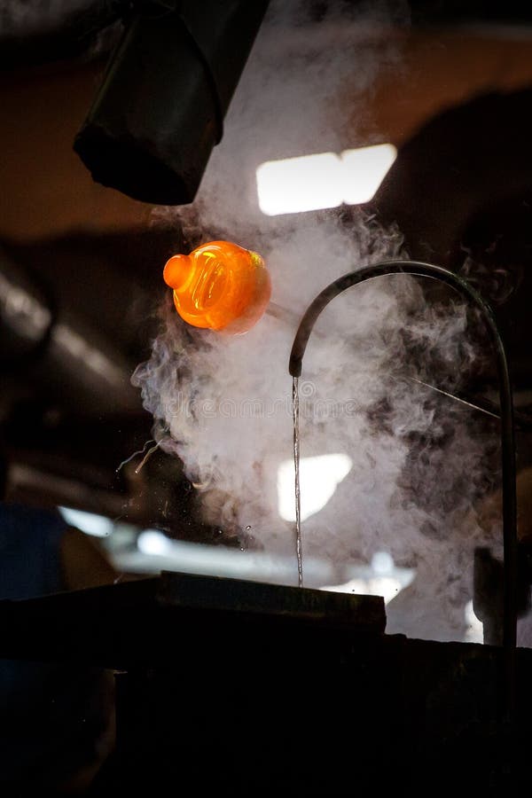 Glass Blower Forming Piece of Glass, Water Cooling. Stock Photo Image