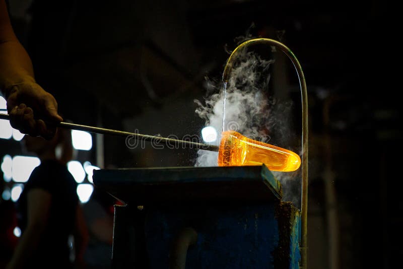 Glass Blower Forming Piece of Glass, Water Cooling. Stock Photo Image