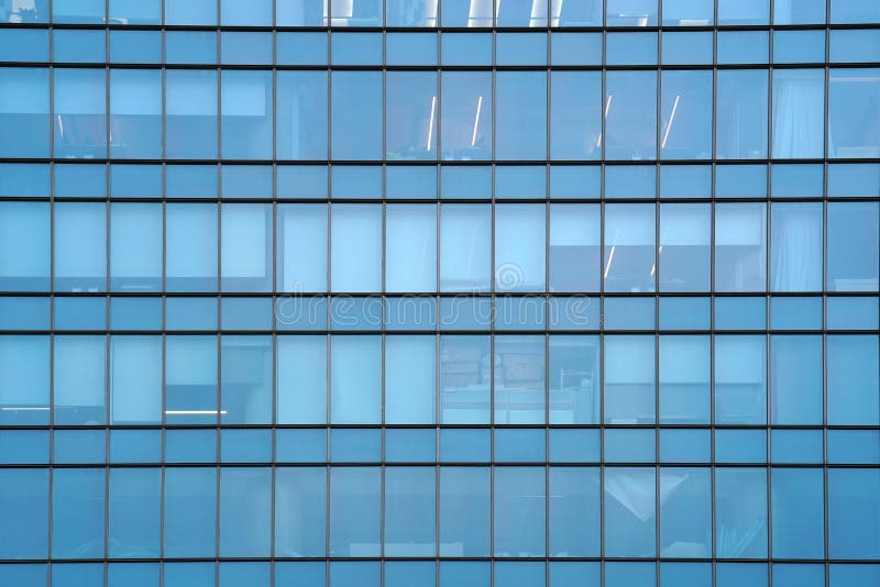 Glass blue square Windows of facade modern city business building skyscraper. Modern apartment buildings in new neighborhood. Windows of a building, texture royalty free stock photography Glass blue square Windows of facade modern city business building skyscraper. Modern apartment buildings in new neighborhood. Windows of a building, texture royalty free stock photography