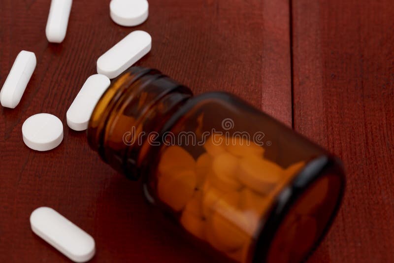 Glass bottle for pills with white tablets