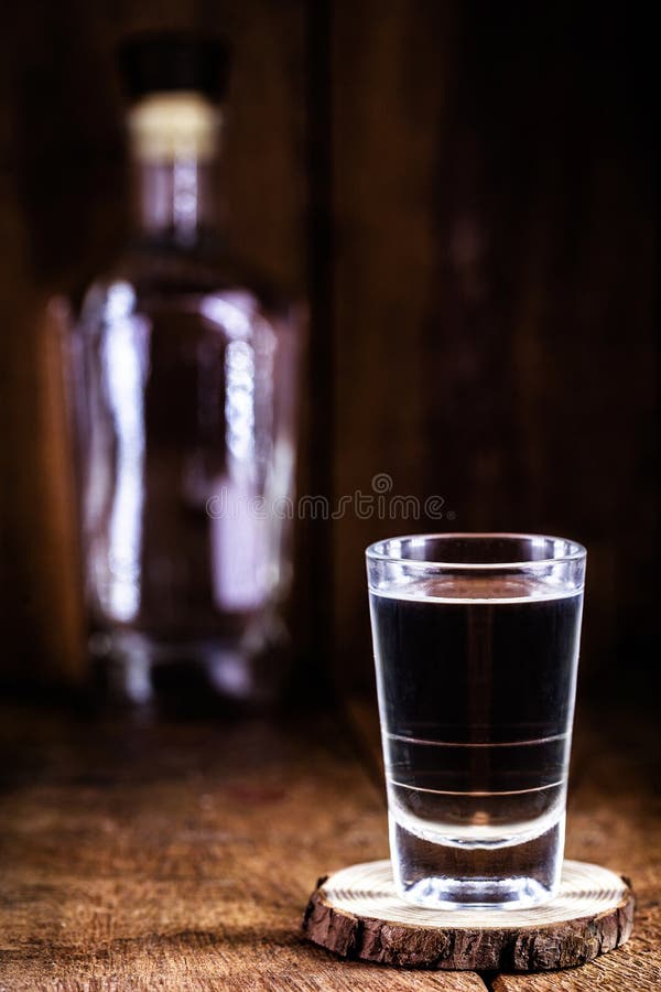 Glass and Bottle of Strong Distilled Alcohol, Brandy, Sugar Canebased Drink Stock Photo Image