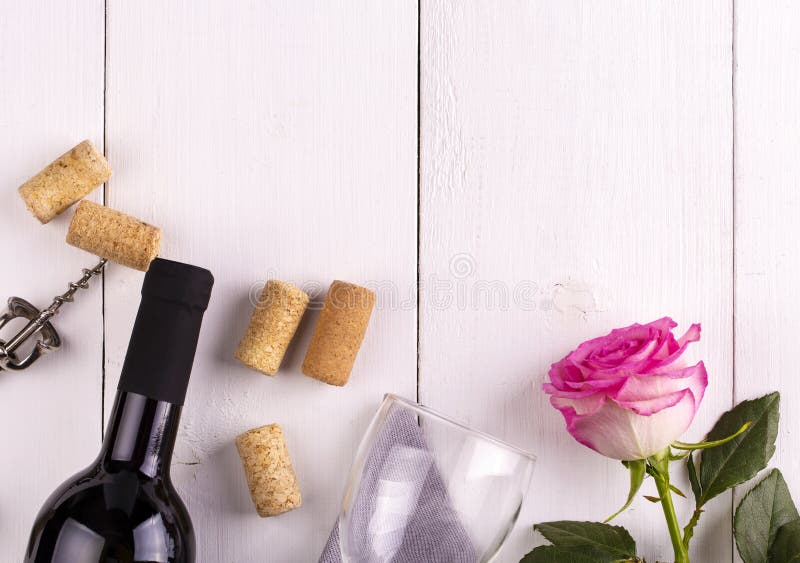 The Glass Bottle of Wine with Corks and Rose on White Wooden Table Stock Image Image of