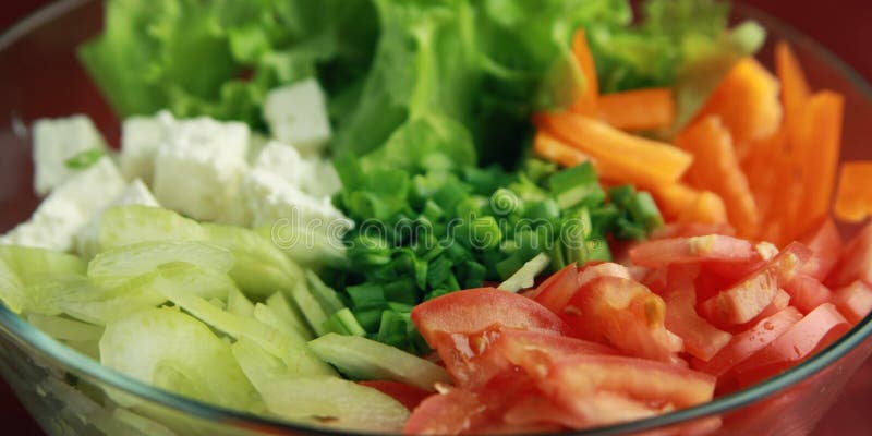 Glass bowl with cutted vegetables. Close up.