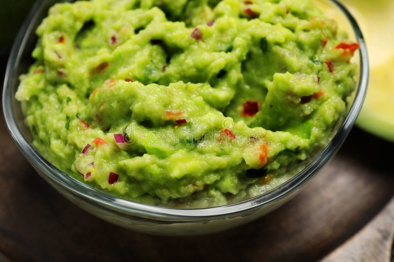 Glass bowl with delicious guacamole on table, closeup royalty free stock photo