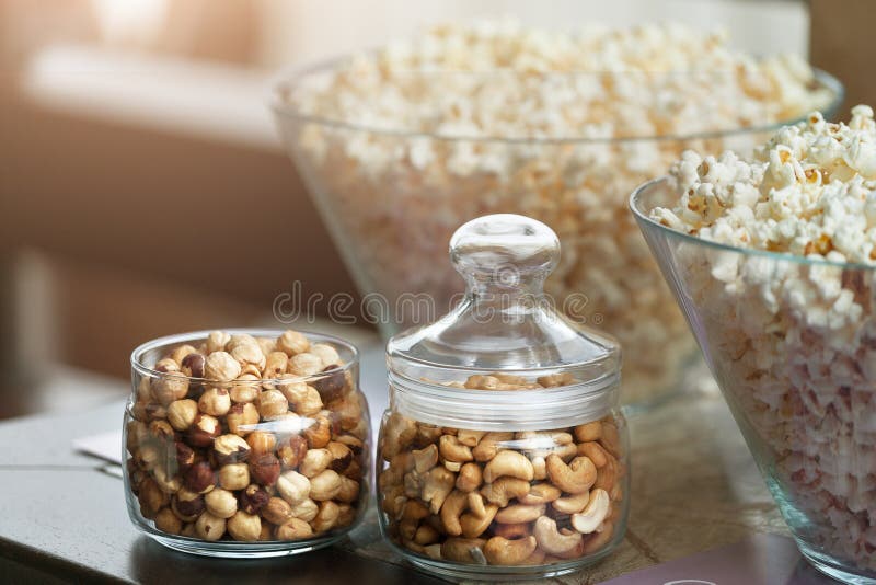 Glass Bowls with Popcorn and Jars with Nuts Stock Image Image of