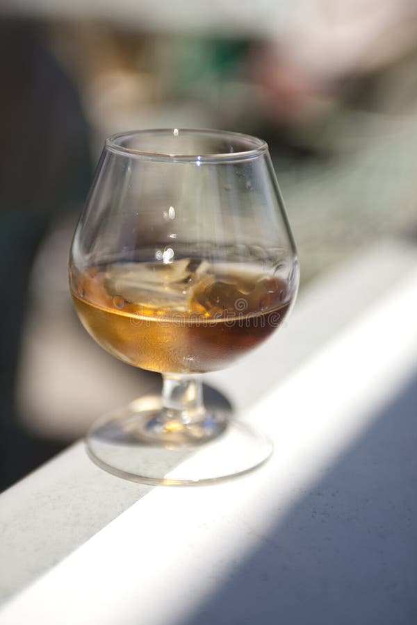 Glass of brandy with ice stock photo. Image of shiny 28202360