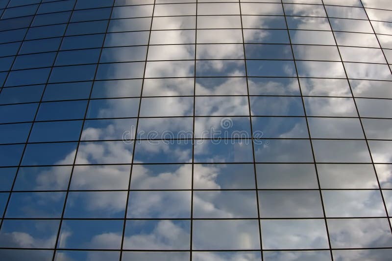 Glass building wall in the clouds