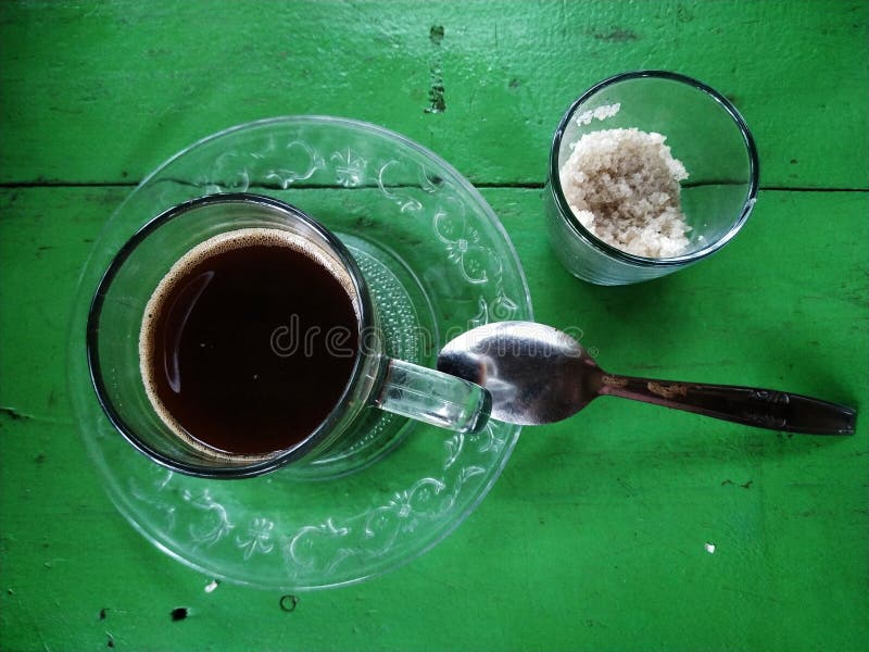 Glass of Coffee, Sugar and a Spoon, on Green Background Stock Image