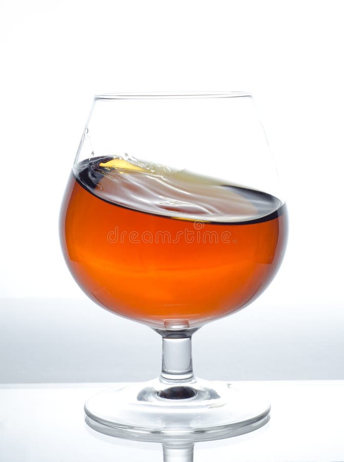 Glass with cognac stock photo. Image of drink, stain 25075816
