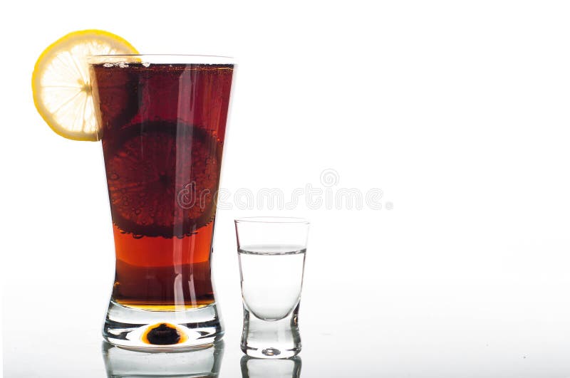 Glass of cola with sliced lemon and shot of vodka royalty free stock photos Glass of cola with sliced lemon and shot of vodka royalty free stock photos
