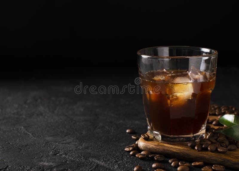 Glass cold brew coffee with ice on black stock photography