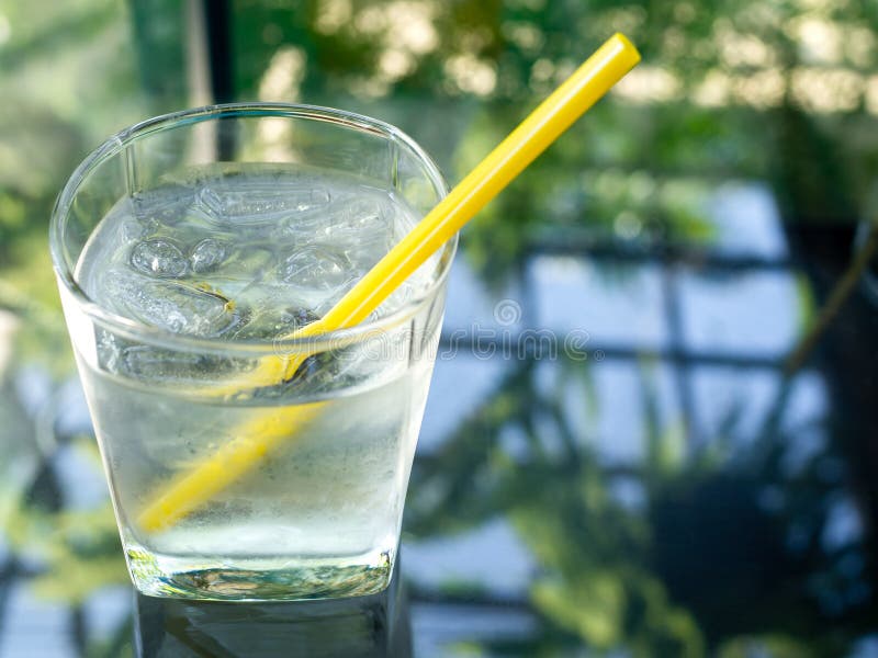 A Glass of Cold Drinking Water with Yellow Straw Stock Image Image of