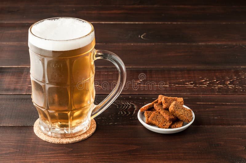 Glass Of Cold Frothy Lager Beer And Plate Of Snacks On Wooden Ta Stock Image - Image of plate ...