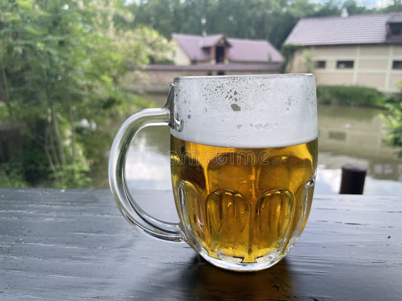 A glass of cold light beer in a summer bar stock photo