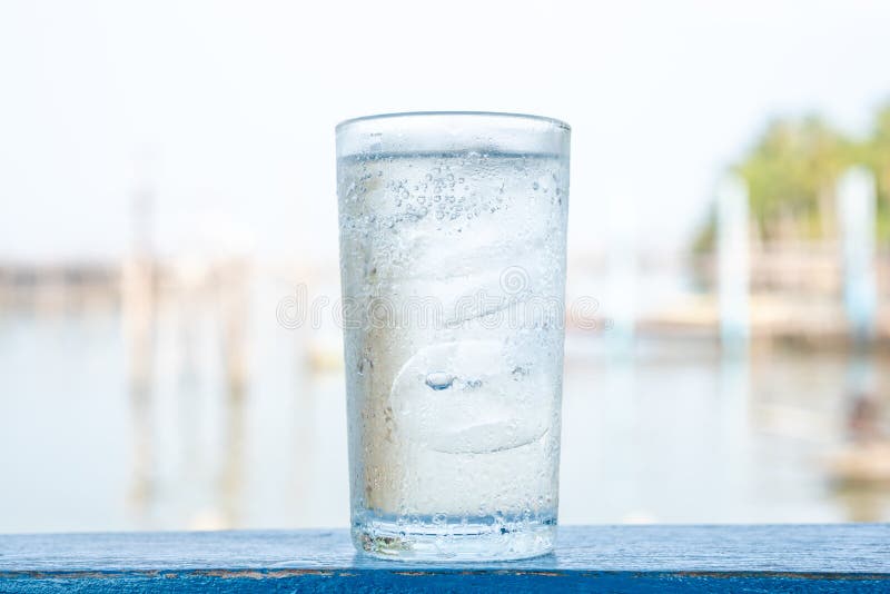 Glass cold water with ice stock photo