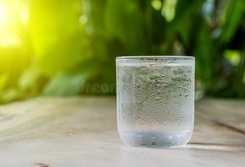 Glass cold water on wooden floor. stock photography