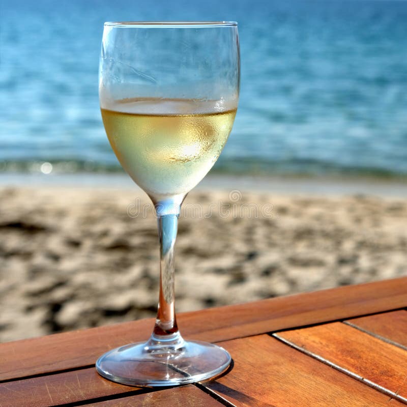 Glass cold white wine mediterranean beach table square stock photography