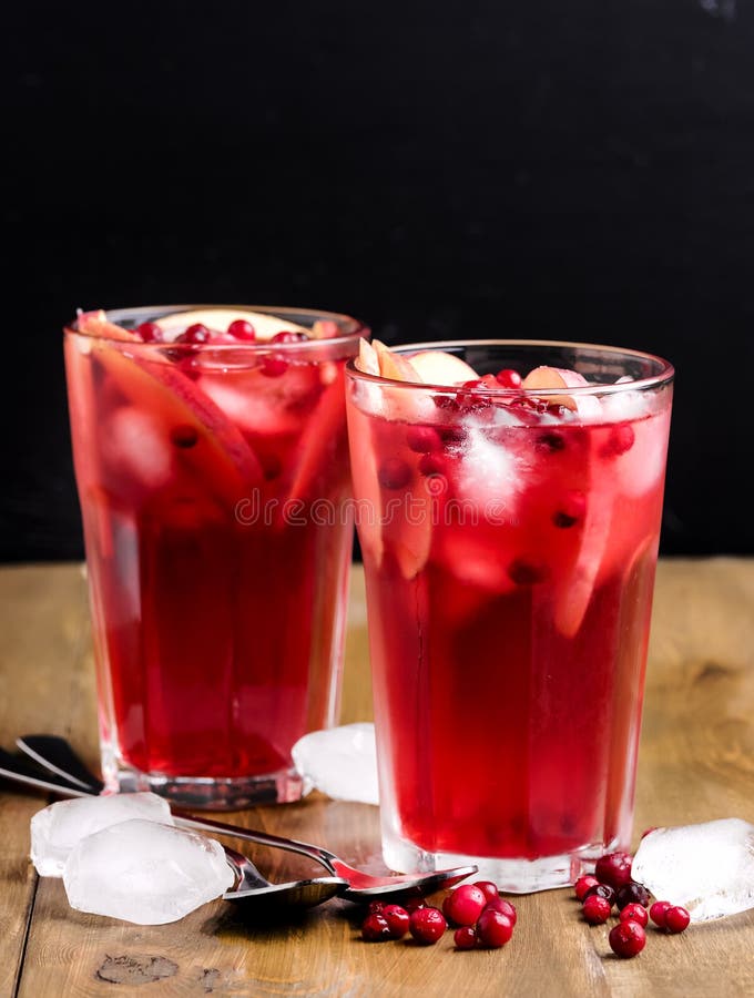 Glass of Cold Winter Drink With Fresh Cranberry and Apple Cold Drink Ice Vertical Berry Ice Tea