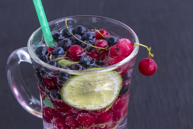 Glass with a Cooling Drink of Berries and Ice. Air Bubbles on Glass