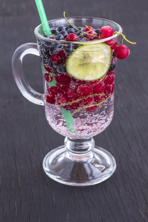 Glass With A Cooling Drink Of Berries And Ice. Misted Glass. Air