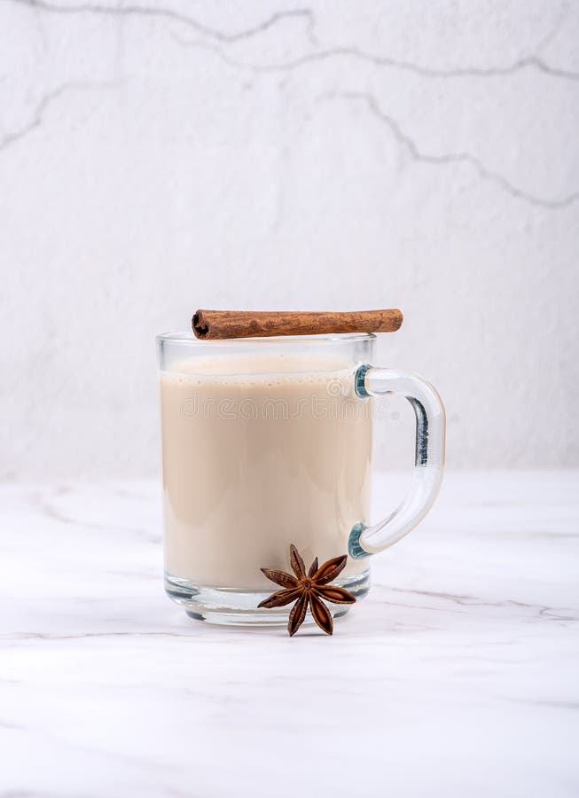 Glass Cup with Masala Chai, Cinnamon Stick and Star Anise. Stock Photo